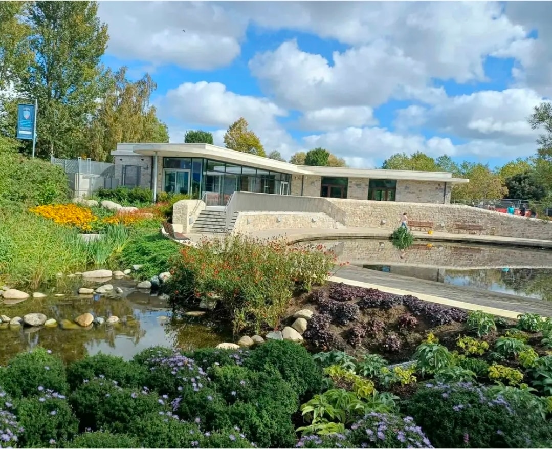 Tymon Intergenerational Centre — completed building with pond